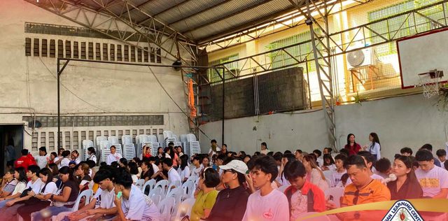 A full gym of students facing the stage at the start of the school year.